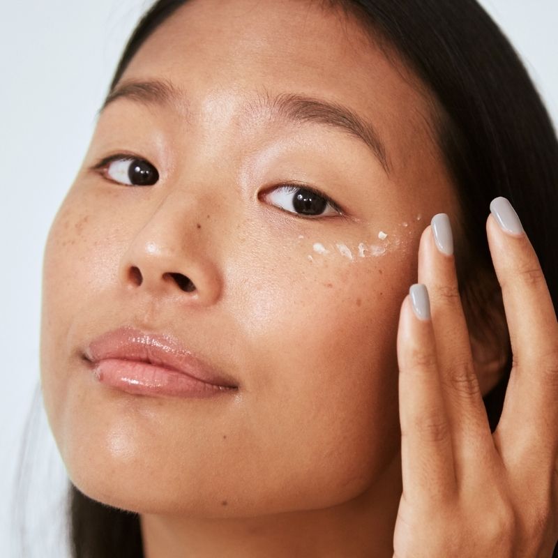 Close-up of skin applying targeted eye treatment to the under-eye area, supporting hydration, brightness, and smoother-looking skin over time.