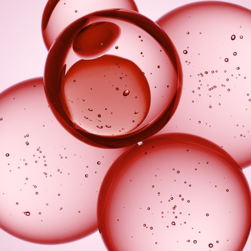 Close-up of red bubbles on a pink background